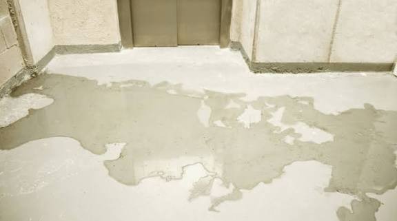 Water damage and peeling finish on an indoor floor